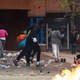 People carrying goods leave a CVS pharmacy near the intersection of Pennsylvania and North avenues April 27, 2015, in Baltimore.
Drew Angerer/Getty Images